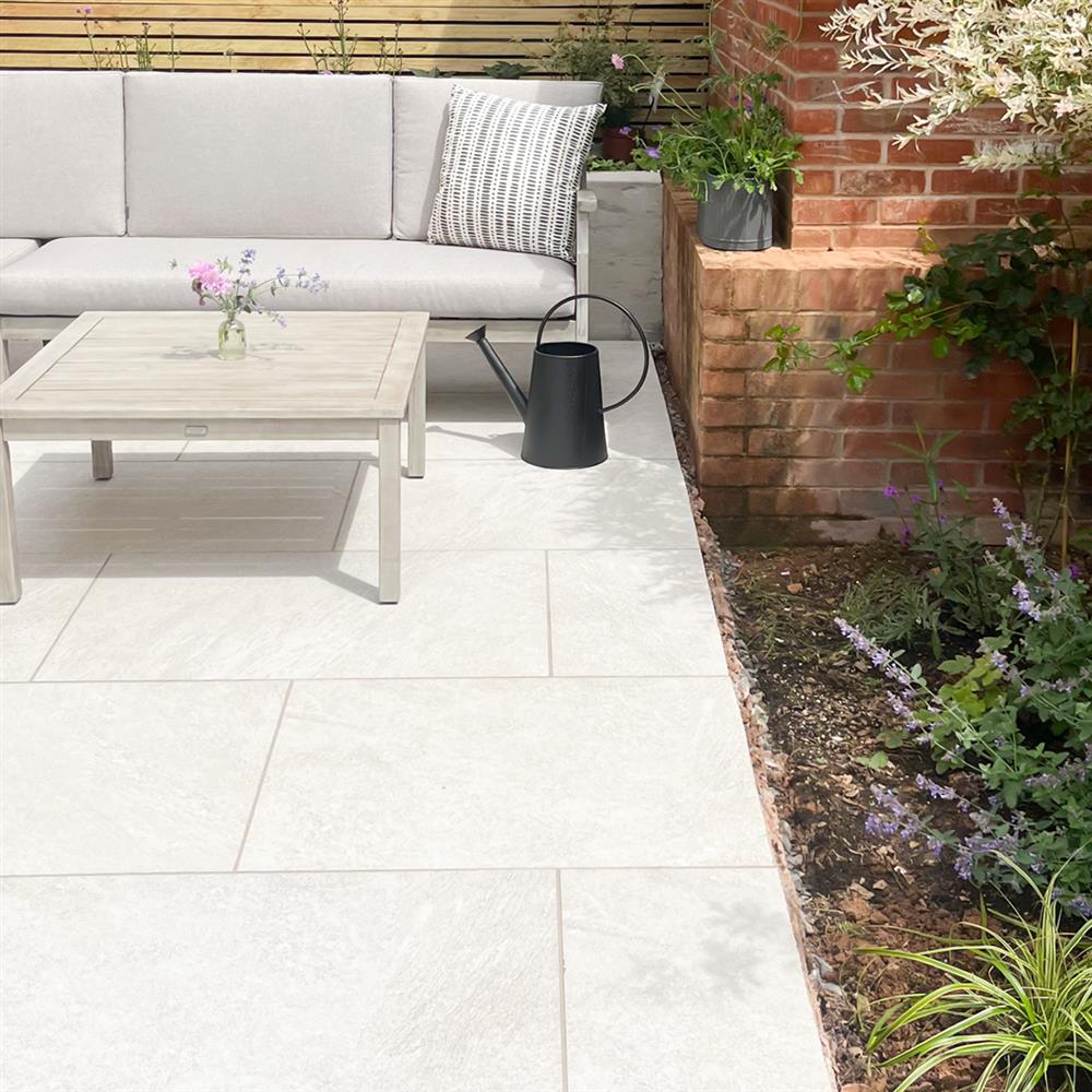 Luxor silver porcelain paving with cut edges meeting a flower bed